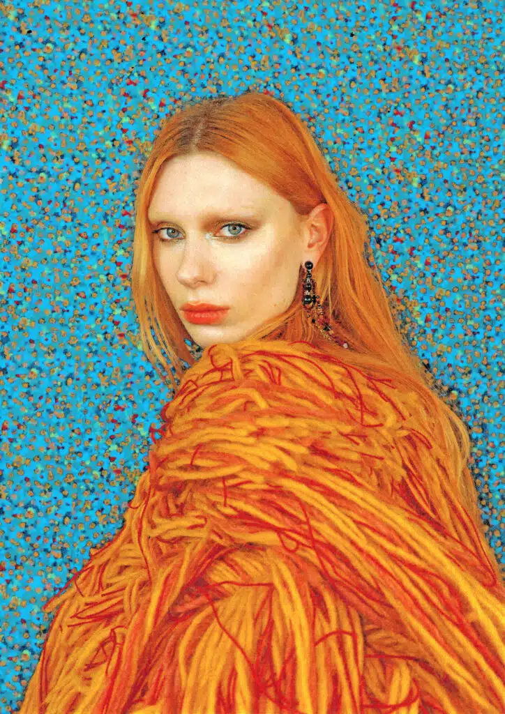 A woman with red hair and orange dress.