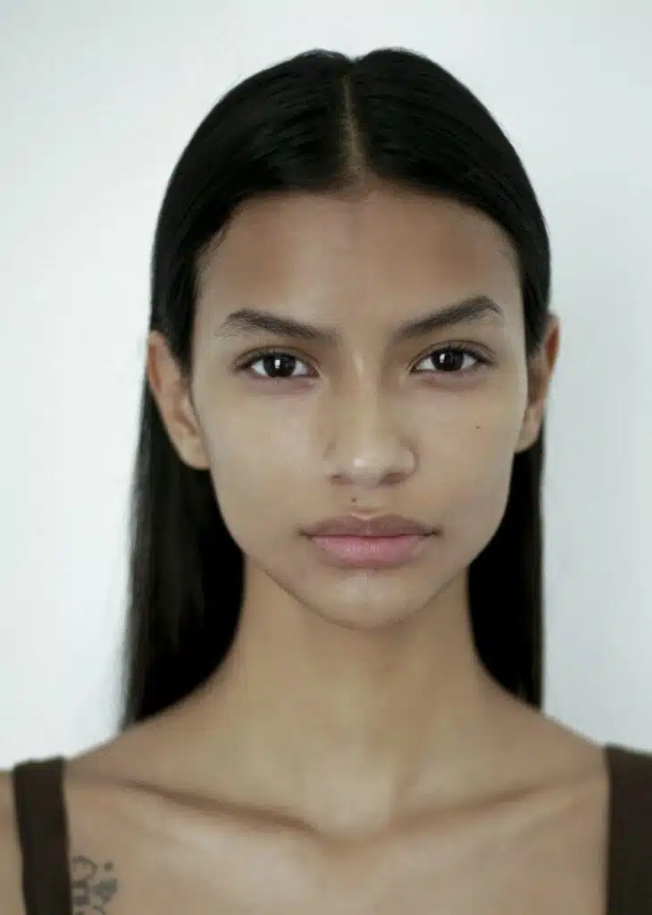 A woman with long hair and no makeup.