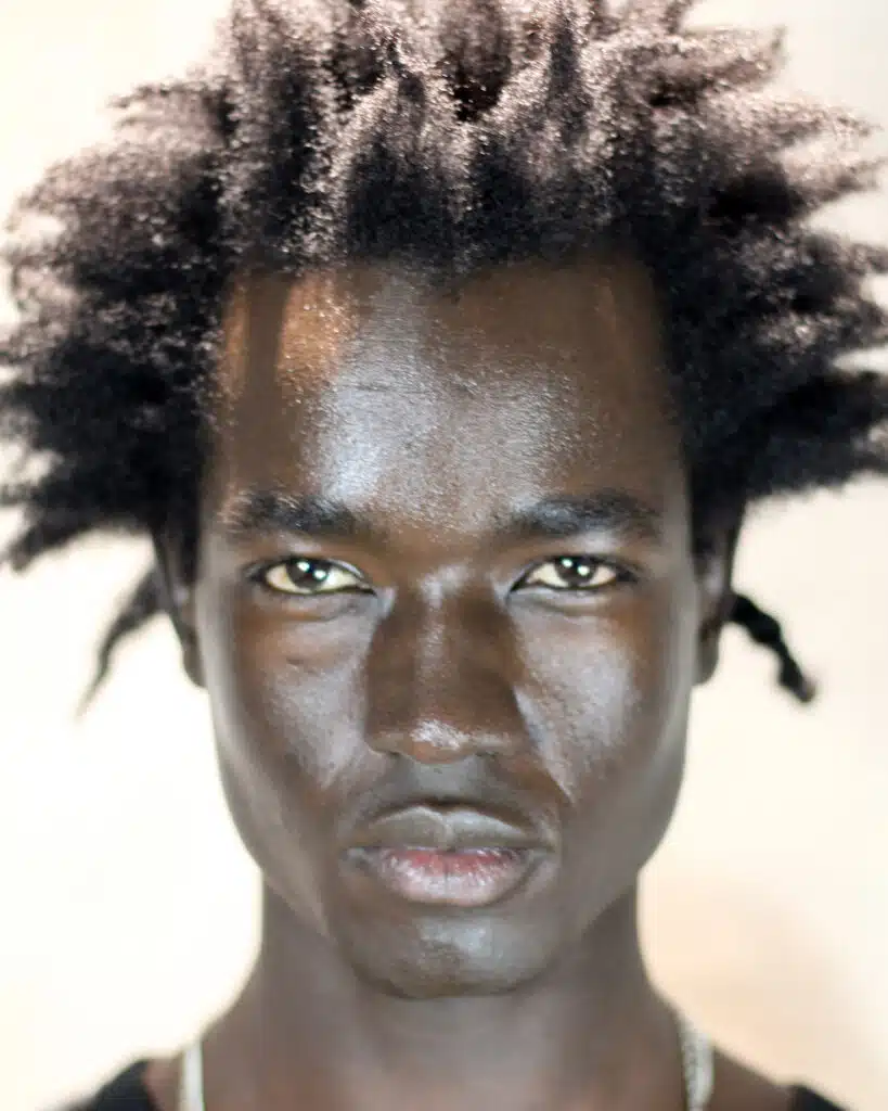 A man with black skin and dark hair.