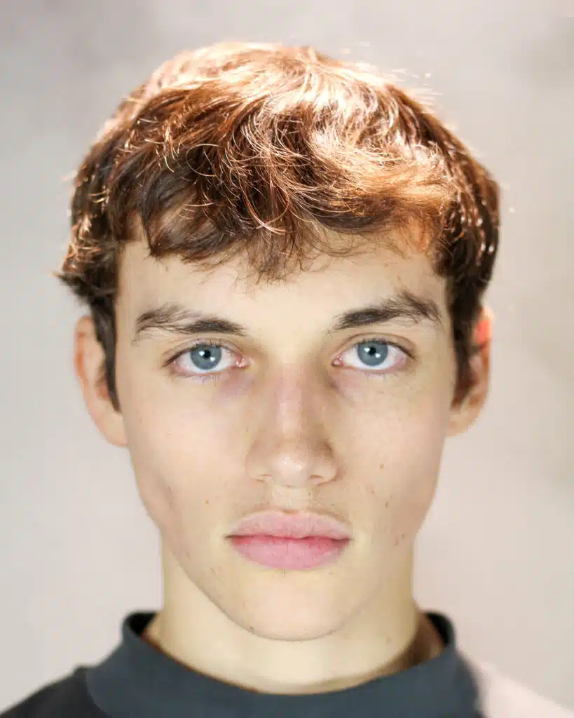 A young man with blue eyes and brown hair.