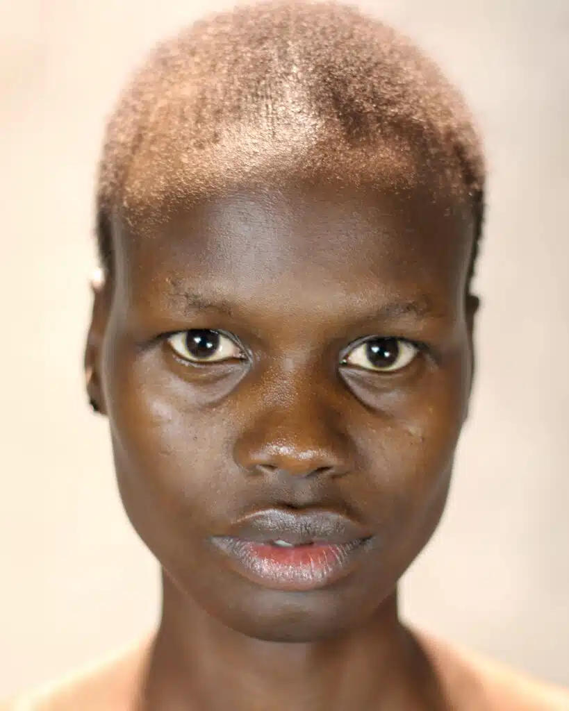 A young man with brown hair and green eyes.