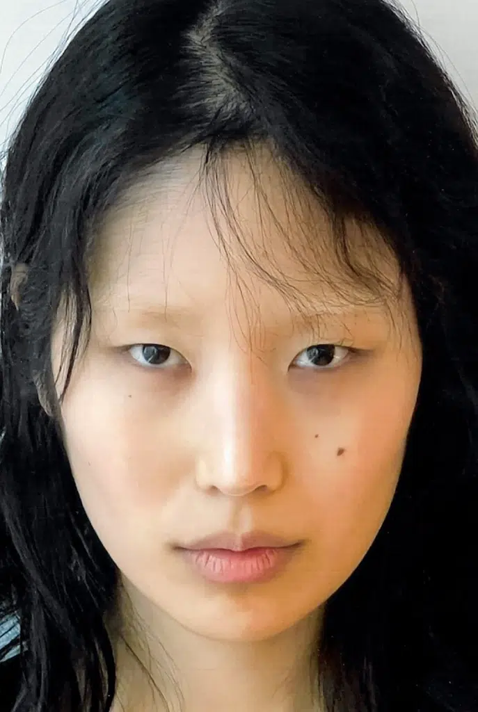 A woman with long black hair and a nose ring.