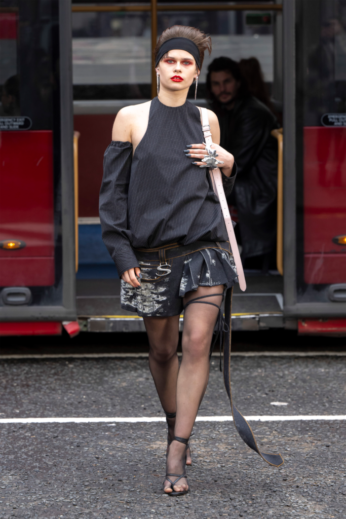 A woman in black dress walking on the street.