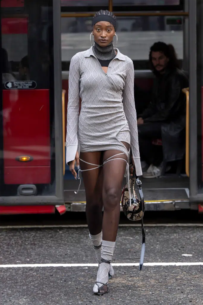 A woman in white dress walking on the street.