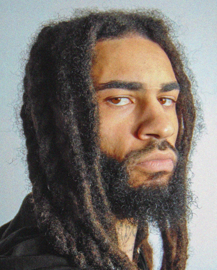 A man with long dreadlocks and a beard.