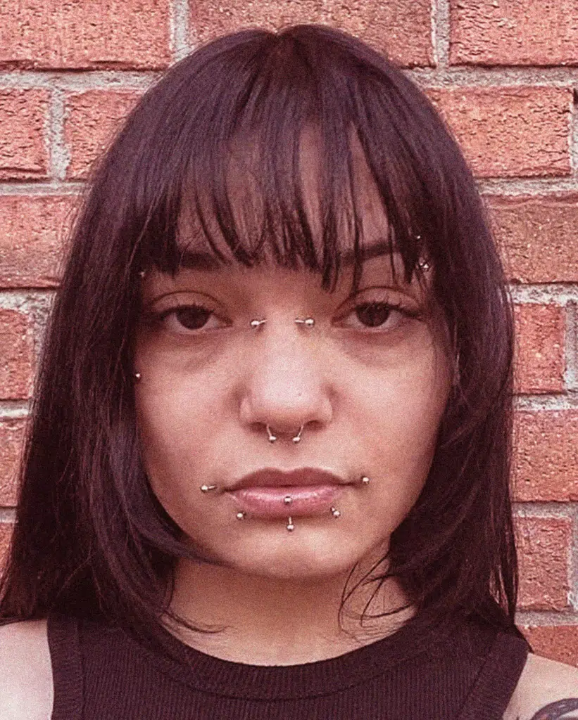 A woman with bangs and no makeup on.