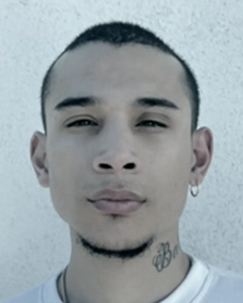 A man with tattoos on his face and neck.