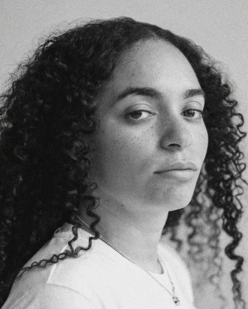 A black and white photo of a woman with long hair.