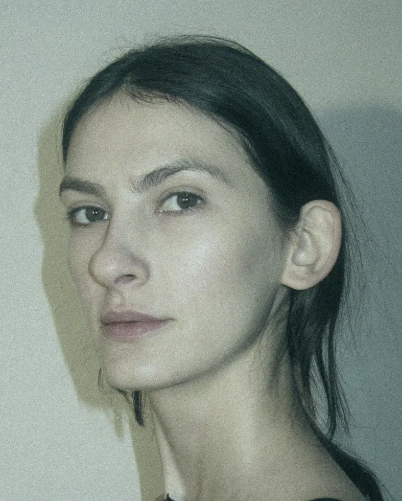 A woman with long hair and a nose ring.