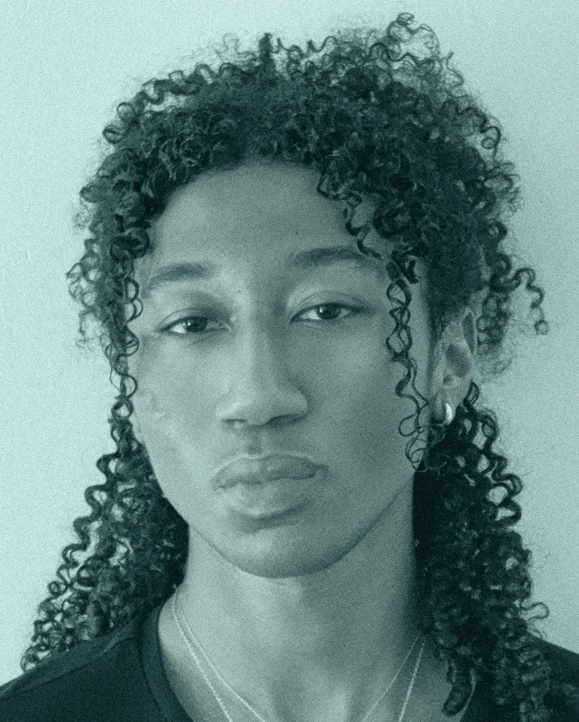 A black and white photo of a person with long hair.
