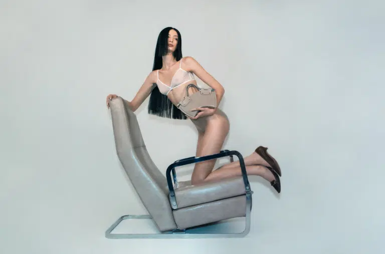 A woman in lingerie sitting on top of a chair.