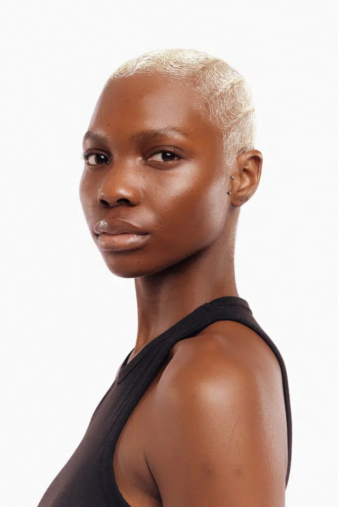 A woman with short hair is posing for the camera.